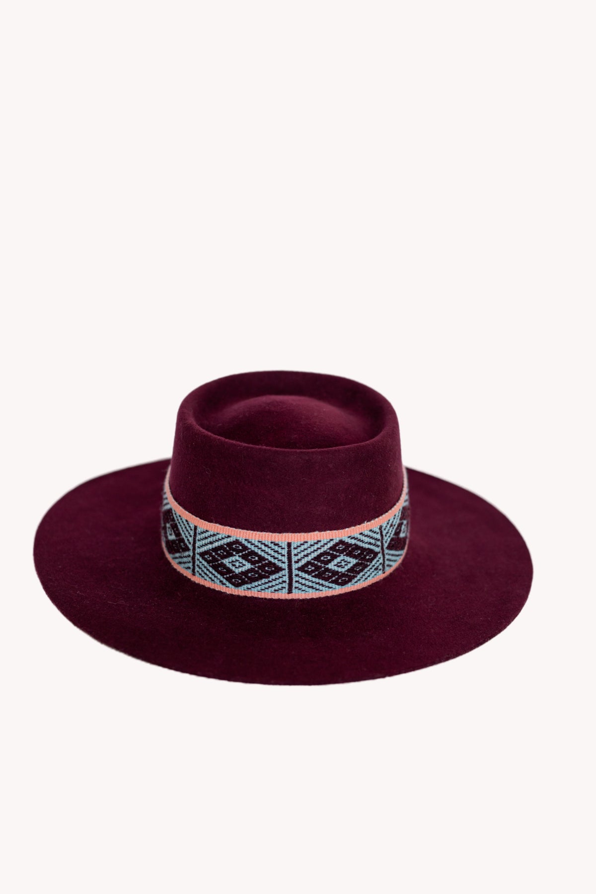 Maroon alpaca wool felt bucket hat with a woven textile band