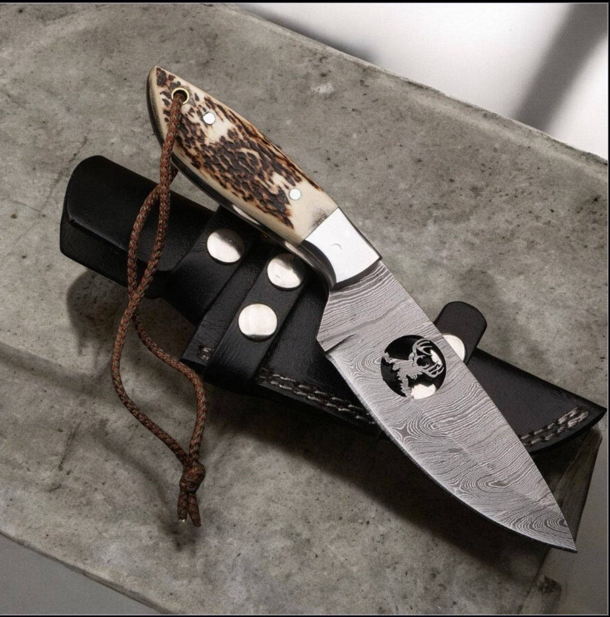 Damascus hunting knife with stag horn handle and leather belt case