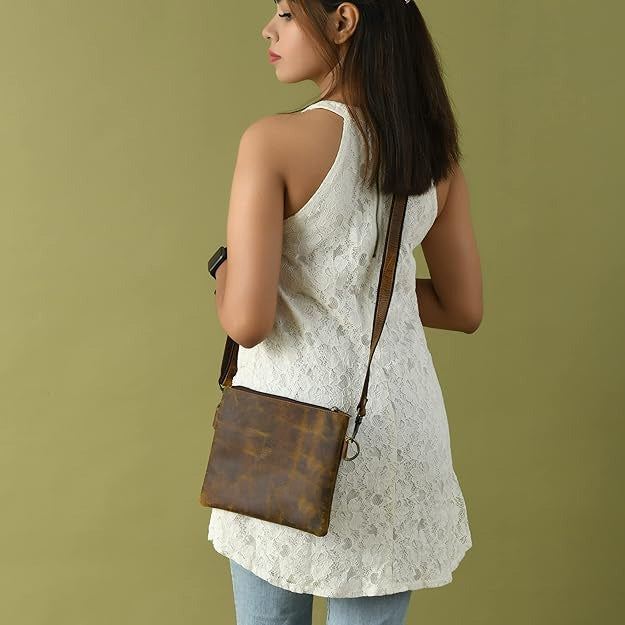 Buffalo leather crossbody sling bag with brass hardware and adjustable strap, view 2