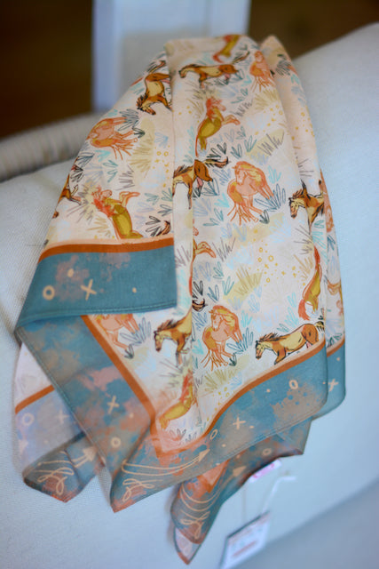 Blush pink wild rag with pastel running horses and a deep turquoise border, view 2
