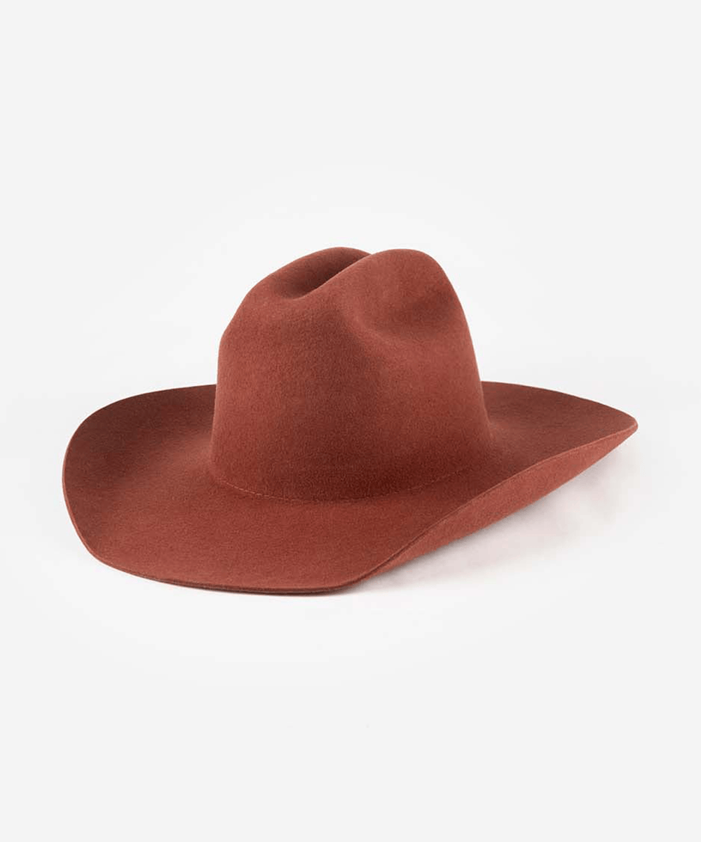 Rusty red felt cowboy hat with a cattleman crown and wide brim
