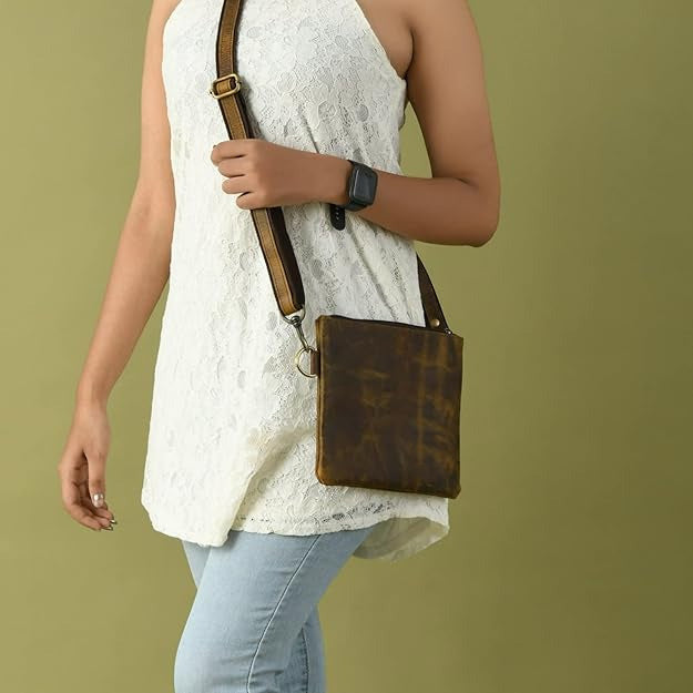 Buffalo leather crossbody sling bag with brass hardware and adjustable strap, view 4