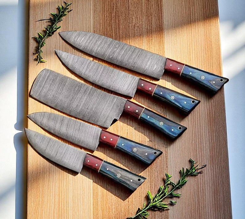Five-piece Damascus knife set with blue and red wood handles